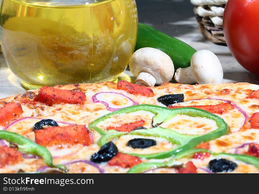 Close up of vegetarian pizza with olive oil and toppings