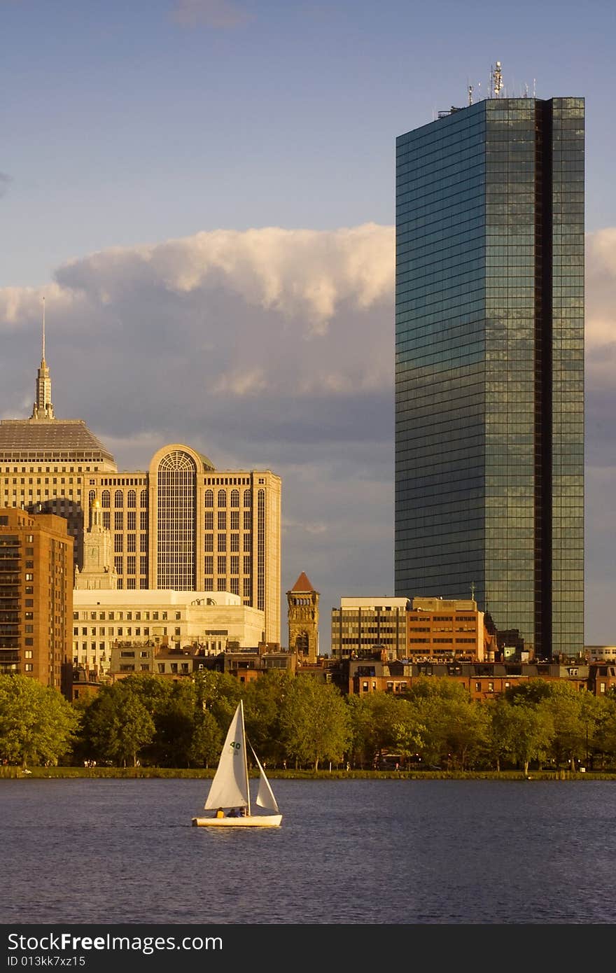 A sailboat on the Charles River glides by the Hancock Tower in Boston's Back Bay area. A sailboat on the Charles River glides by the Hancock Tower in Boston's Back Bay area