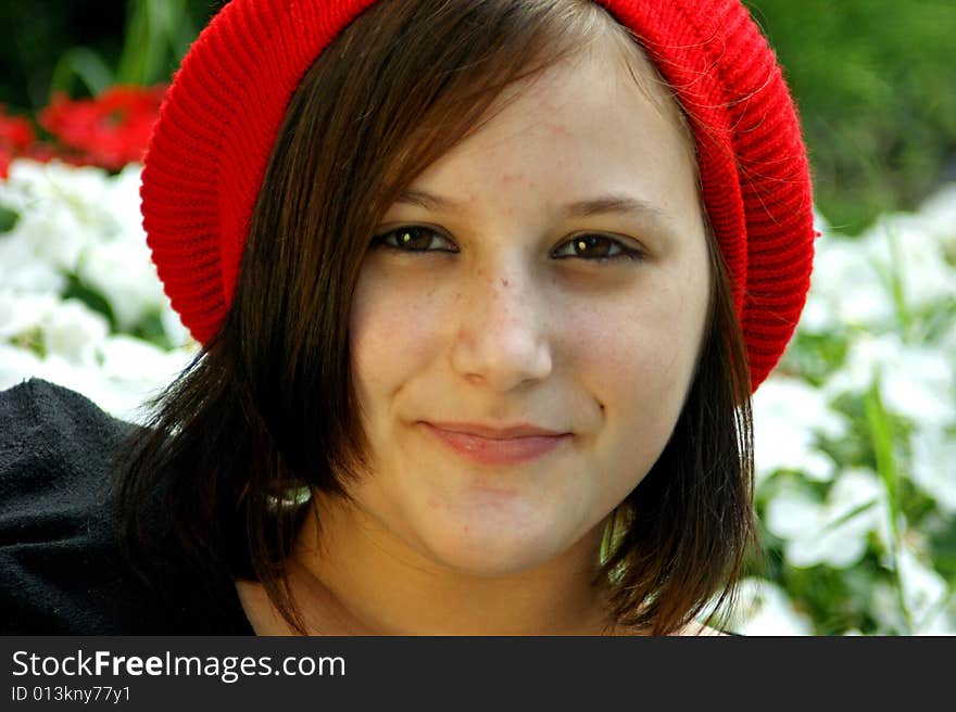 A portrait of a young girl with red cap.