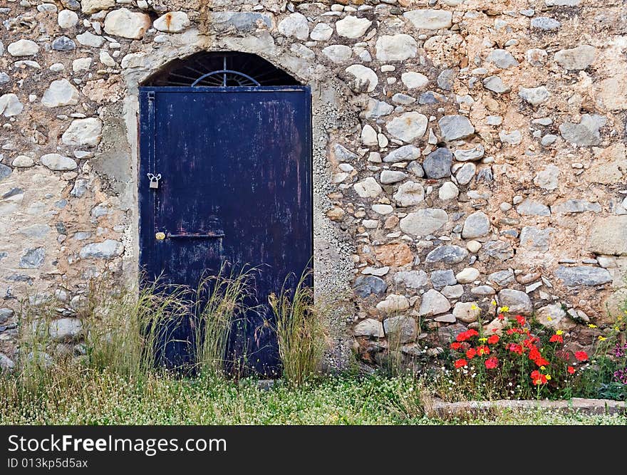 Blue Metallic Door On Stone Building