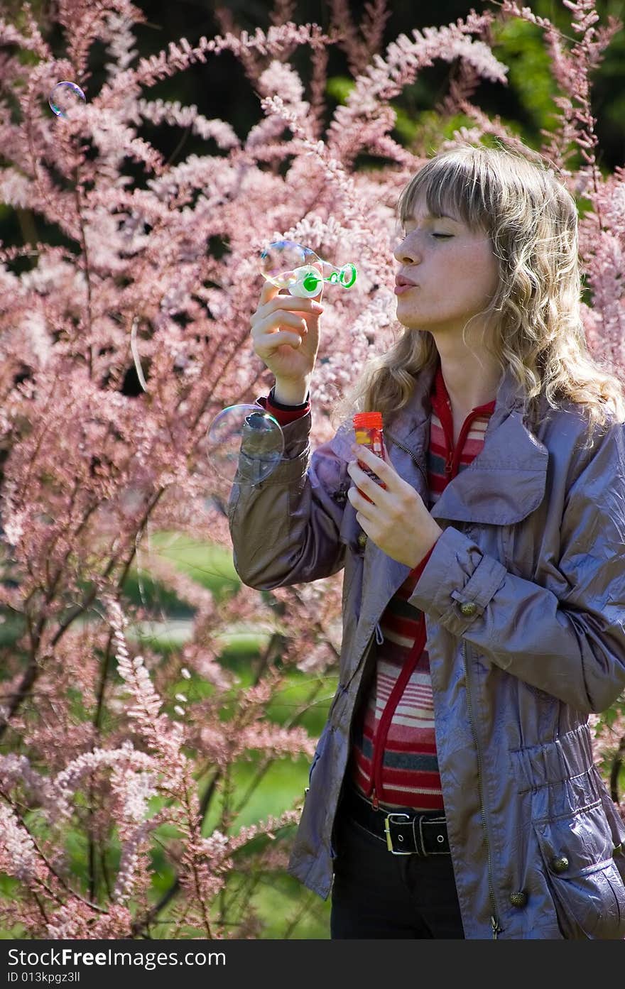 Girl blowing bubble in the park