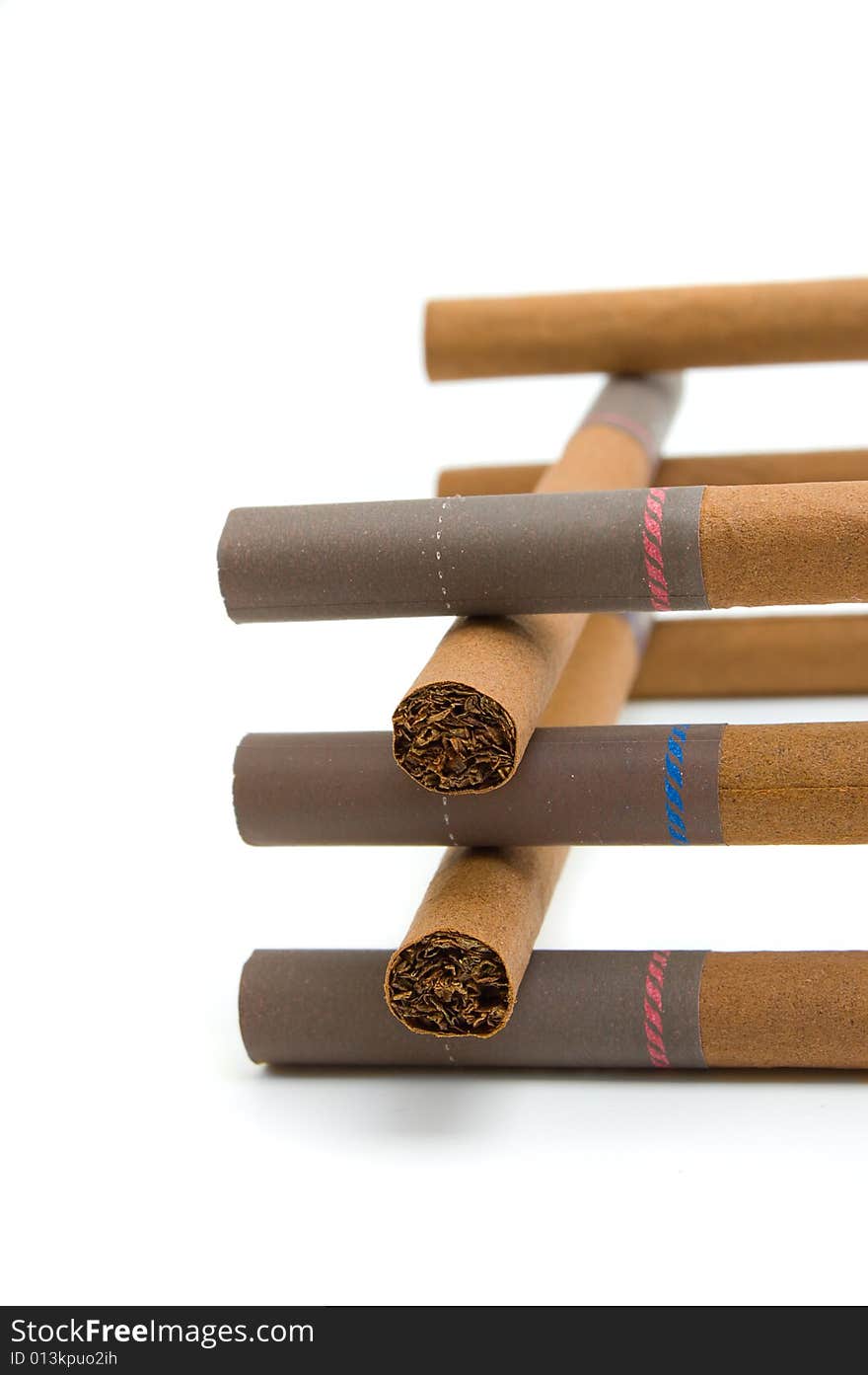 Little brown cigars (cigarettes) in a stack isolated on white background. Little brown cigars (cigarettes) in a stack isolated on white background