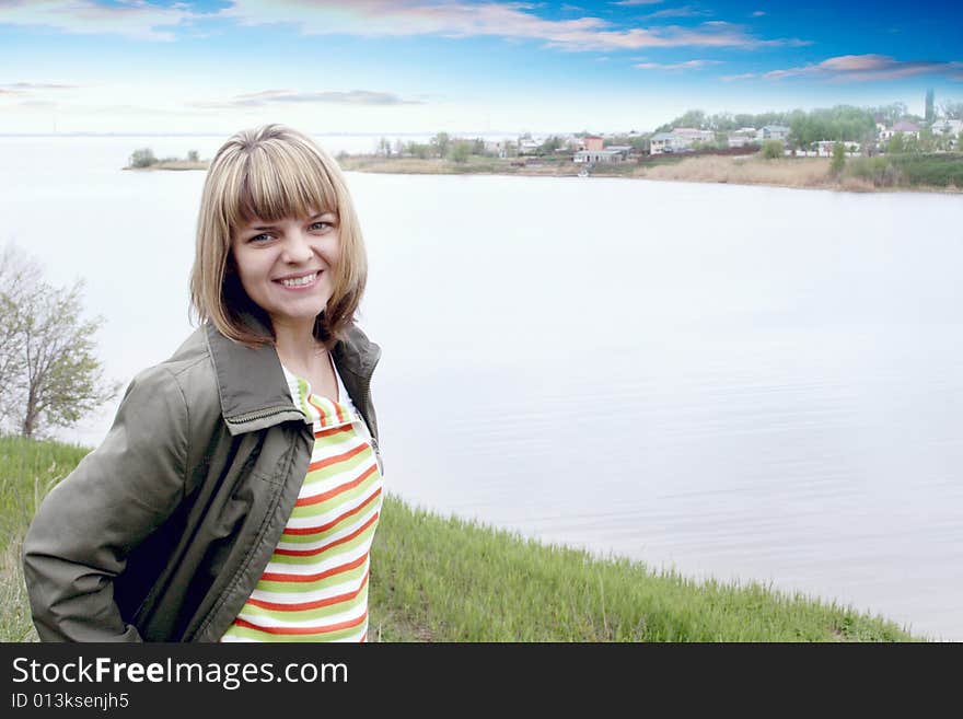 Beautiful making look younger woman on background of the rural river landscape. Beautiful making look younger woman on background of the rural river landscape