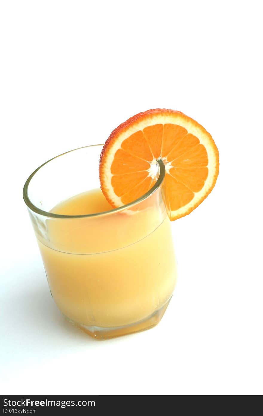 Glass of orange juice and segment of an orange