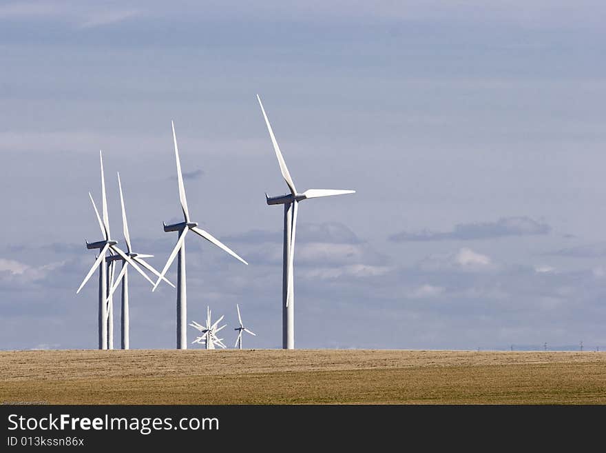 Group of Wind Mills on windfarm on a cloudy day. Group of Wind Mills on windfarm on a cloudy day