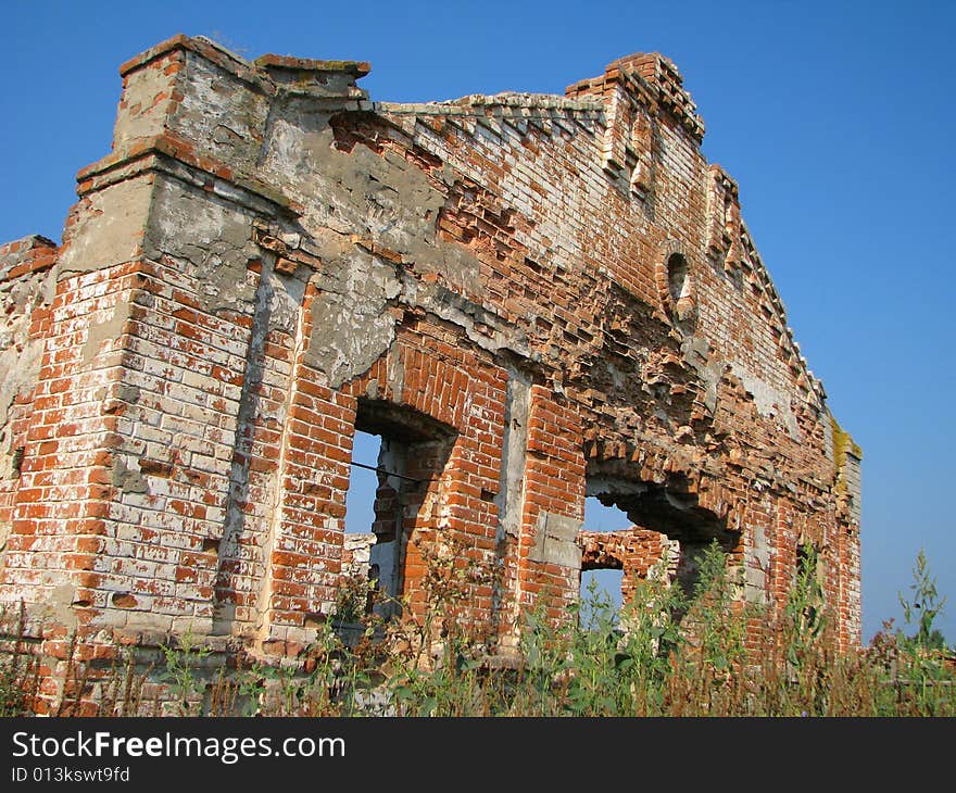 Old ruins of a brick building (farm) in village