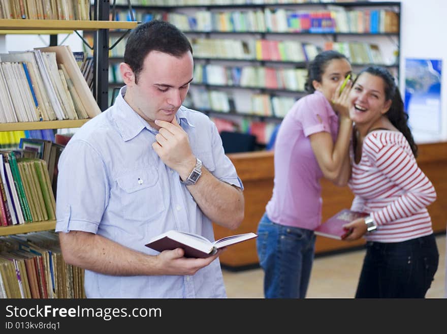 Three students in library