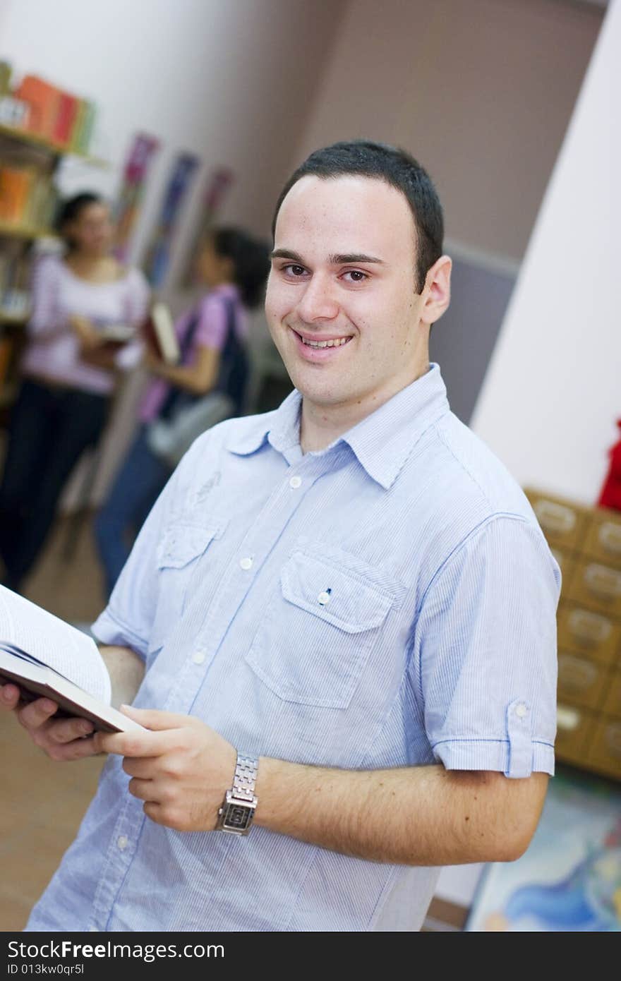 Young student holding book and reading