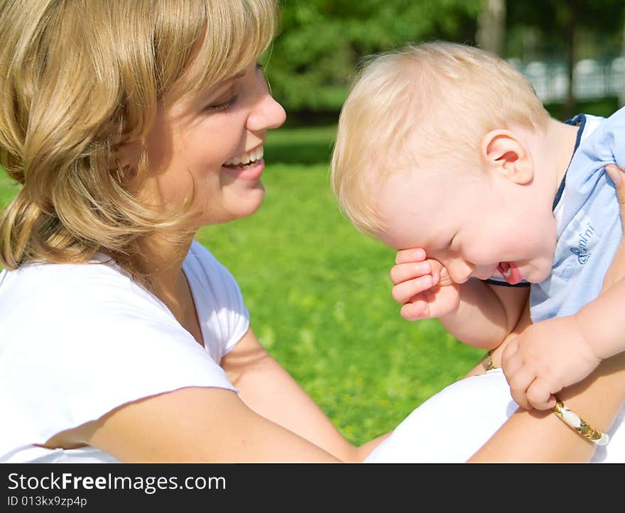 Mother and son rest in the park summer day