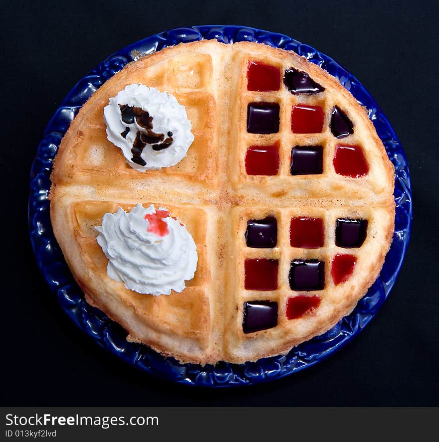 Waffles with cream  isolated on black background