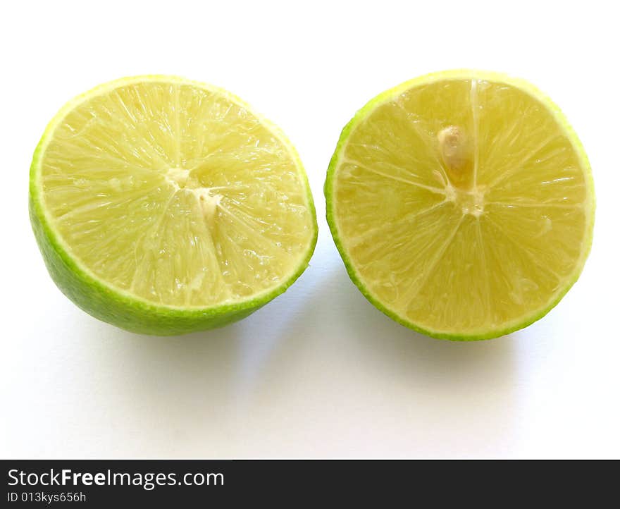 Cut in half lime isolated on white