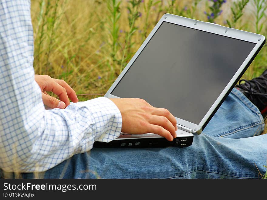 Male hands typing on a laptop