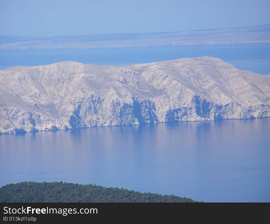 Croatia - view from the Velebit Mountain (Vratnik Pass) to the Adriatic Sea and Kvarner Bay - islands of  Krk and Cres in the background. Croatia - view from the Velebit Mountain (Vratnik Pass) to the Adriatic Sea and Kvarner Bay - islands of  Krk and Cres in the background