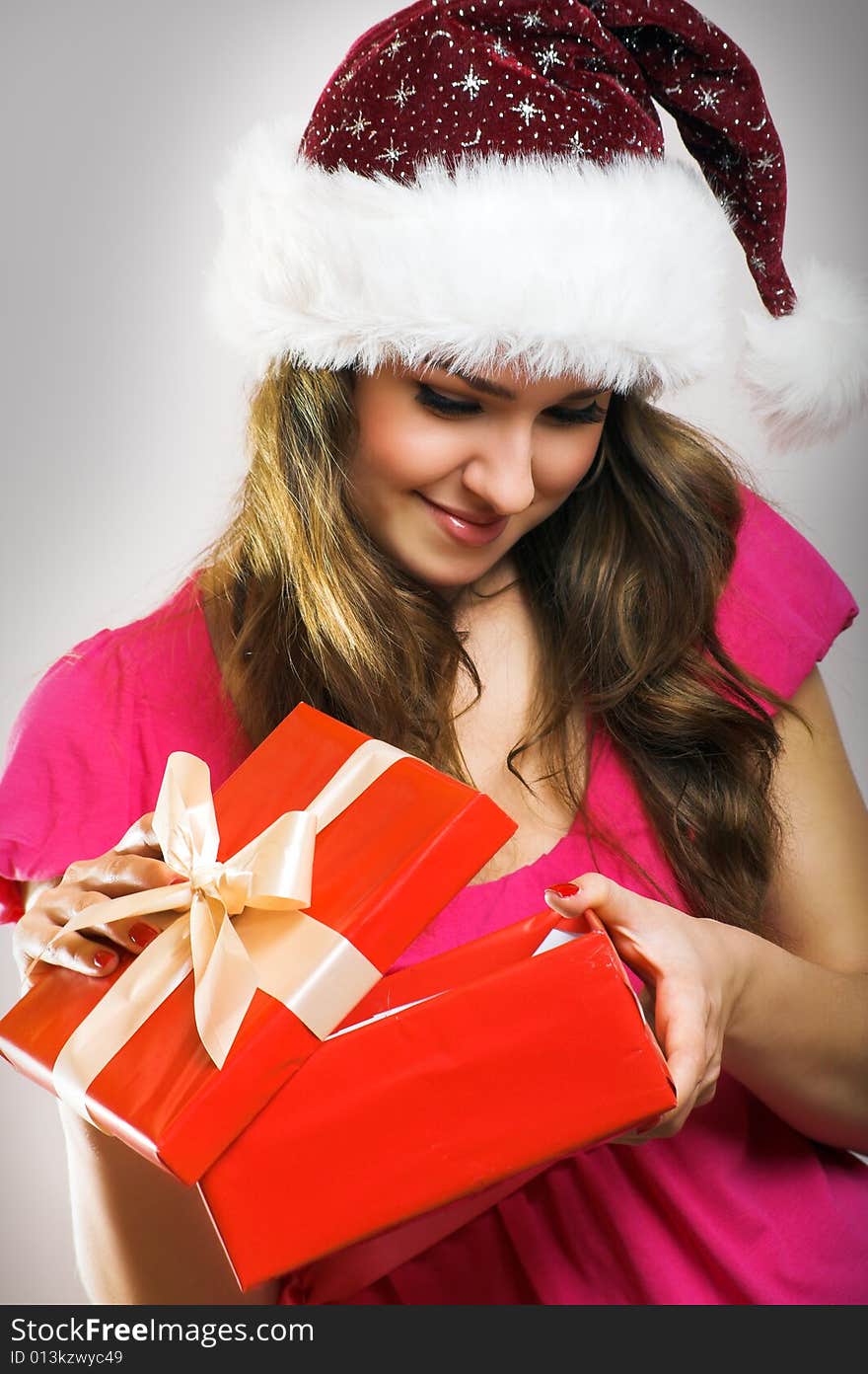 Winter portrait of a beautiful young smiling woman with a christmas cap. Winter portrait of a beautiful young smiling woman with a christmas cap