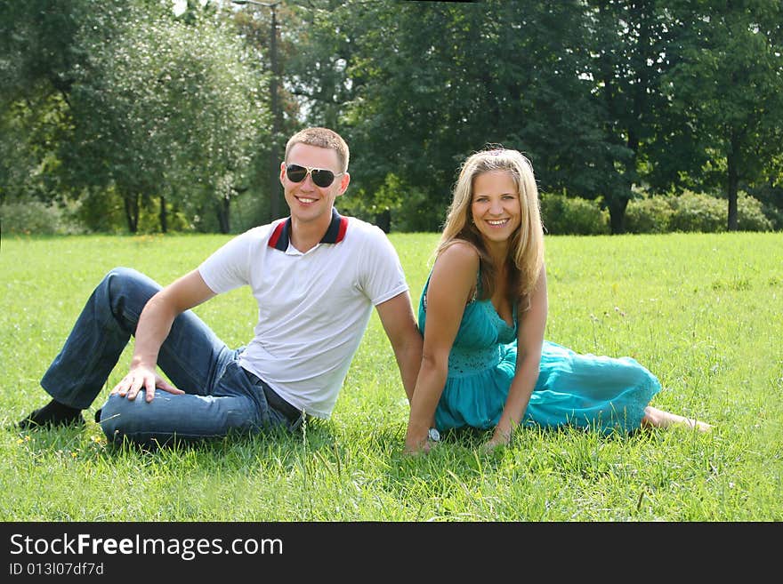 Happy young couple relaxing in park