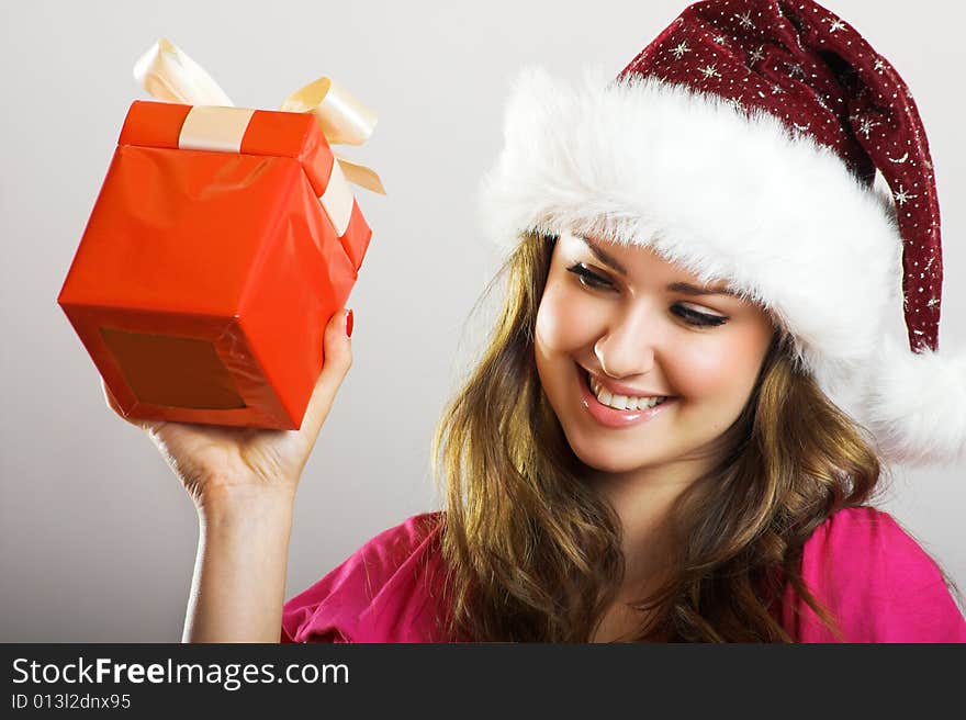 Winter portrait of a beautiful young smiling woman with a christmas cap. Winter portrait of a beautiful young smiling woman with a christmas cap