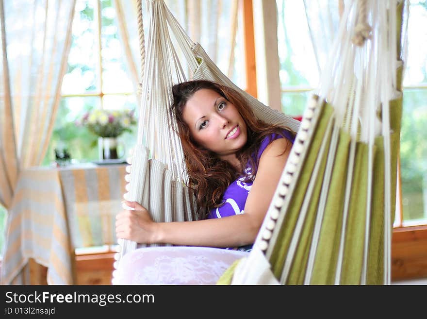 Beautyful long-haired girl relaxing in hammock