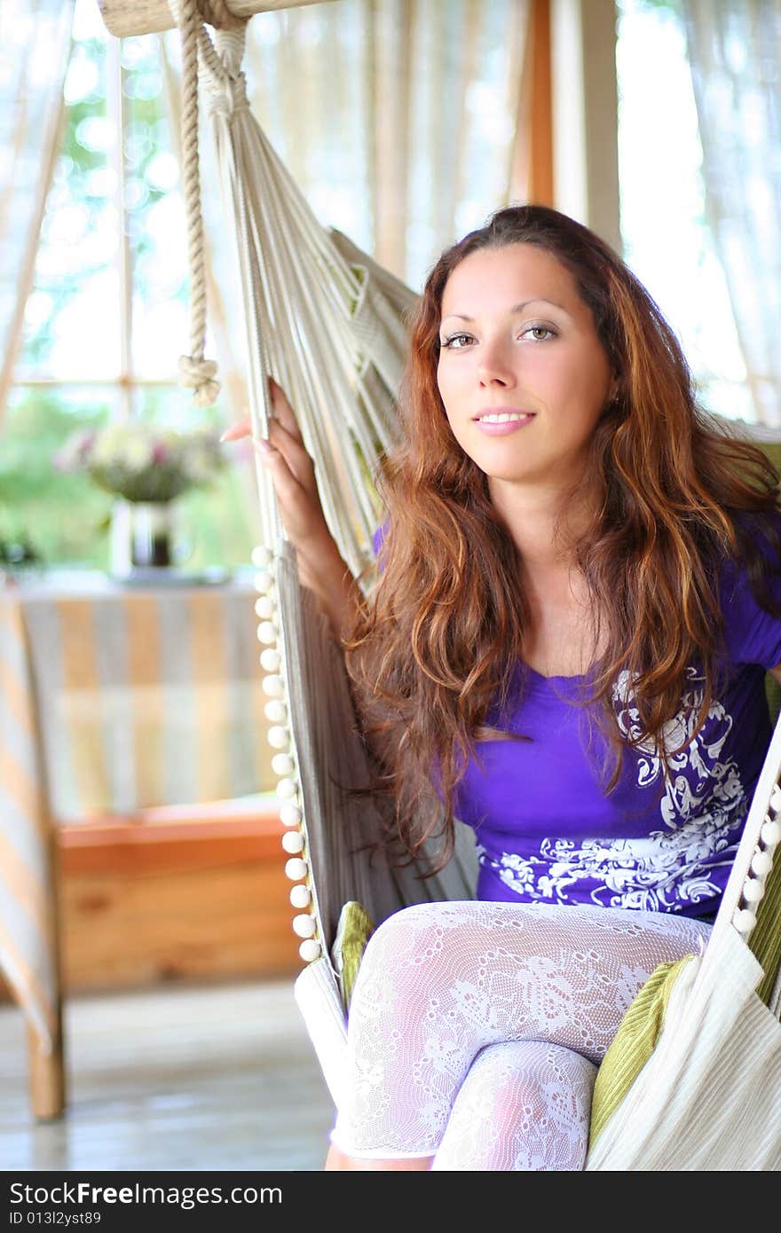 Beautyful long-haired girl relaxing in hammock