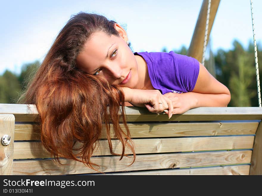 Beautyful long-haired girl relaxing in park