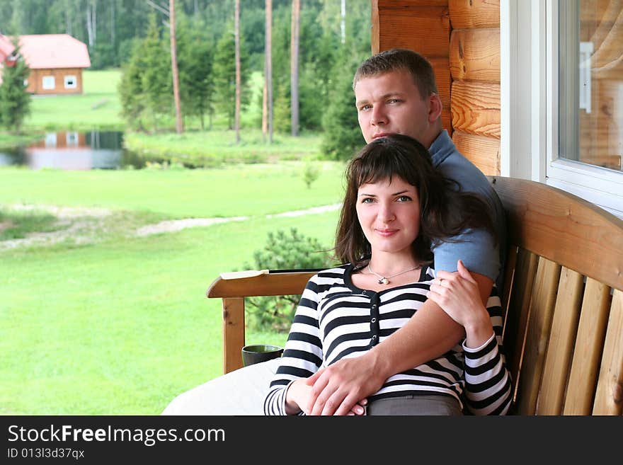 Young couple relaxing on verandah