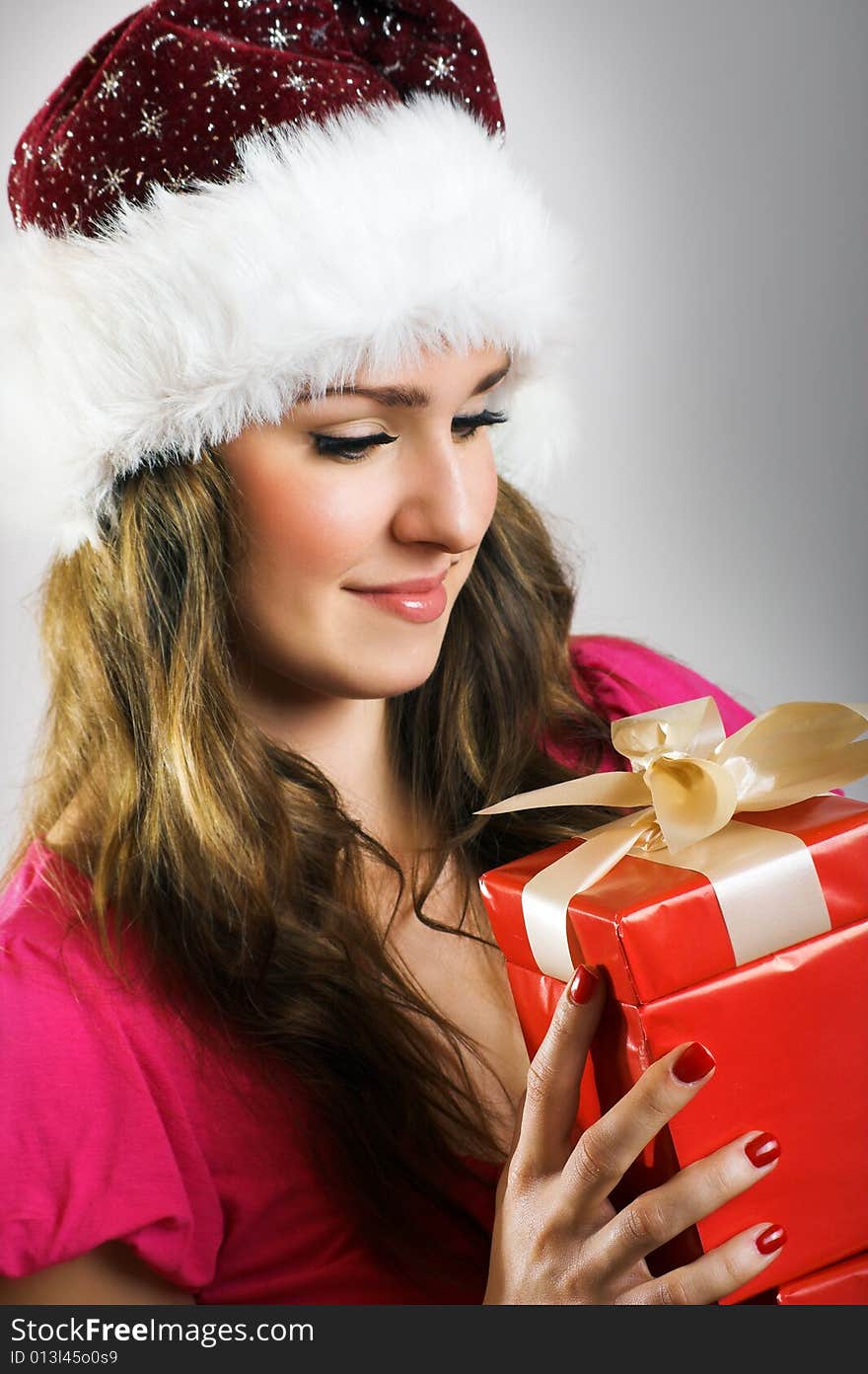 Winter portrait of a beautiful young smiling woman with a christmas cap. Winter portrait of a beautiful young smiling woman with a christmas cap