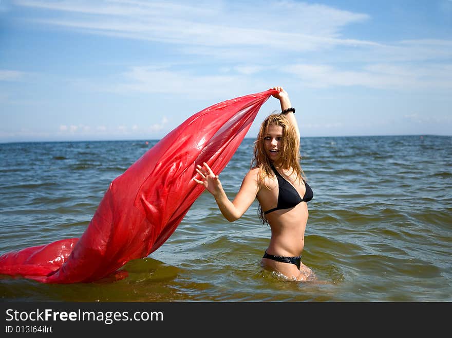 Beautiful girl swimming with red shawl