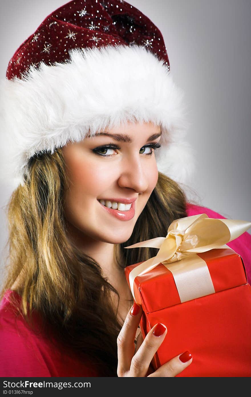 Winter portrait of a beautiful young smiling woman with a christmas cap. Winter portrait of a beautiful young smiling woman with a christmas cap