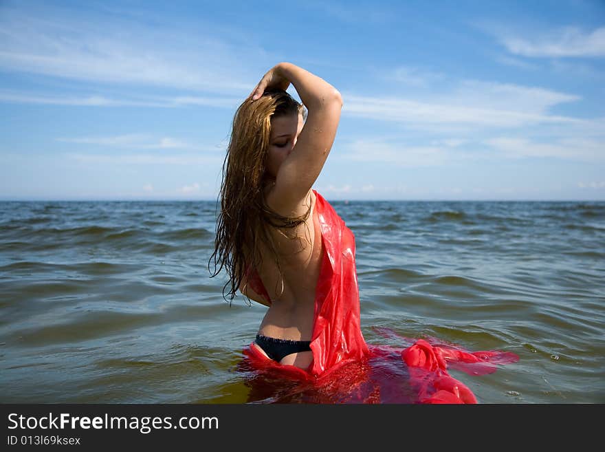 Beautiful girl swimming with red shawl