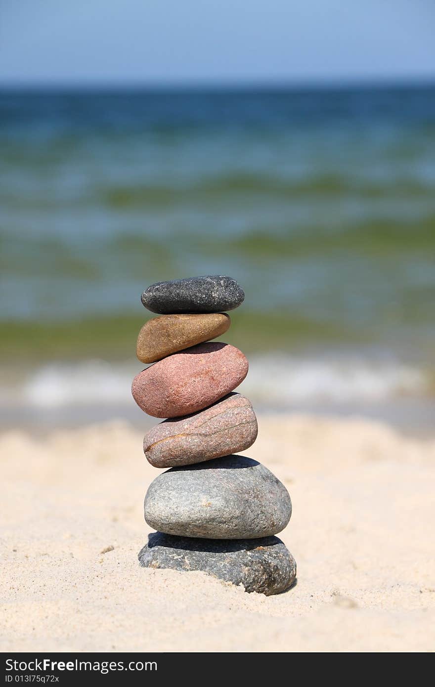 Differently colored pebbles, stacked