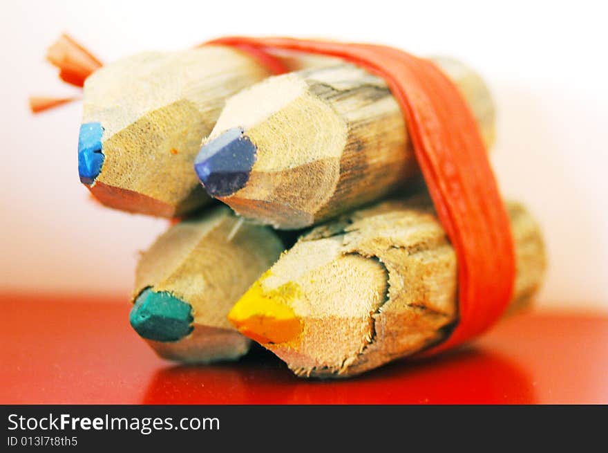 Four colored pencils tied together