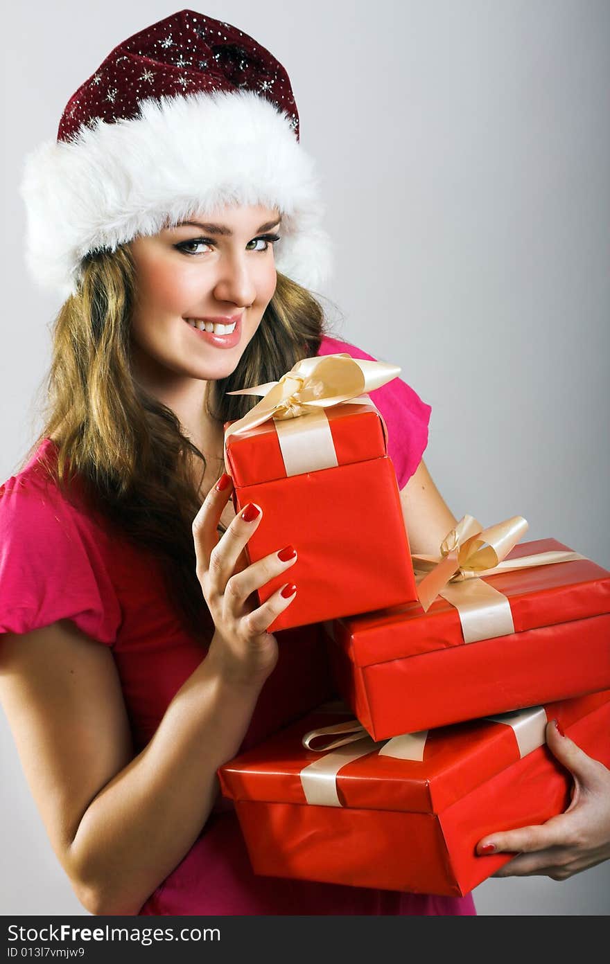 Winter portrait of a beautiful young smiling woman with a christmas cap. Winter portrait of a beautiful young smiling woman with a christmas cap