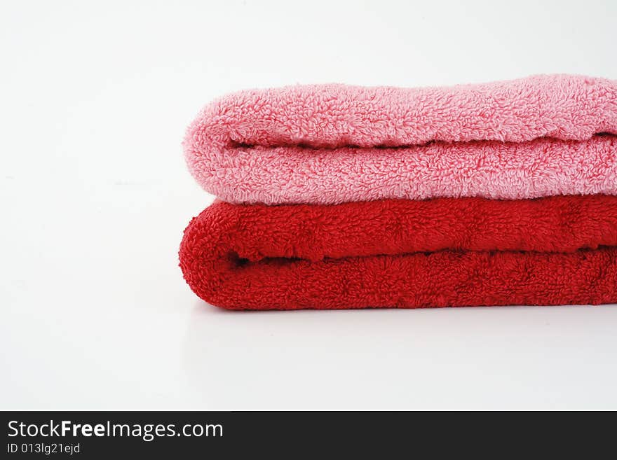 Pink and red towels on neutral background