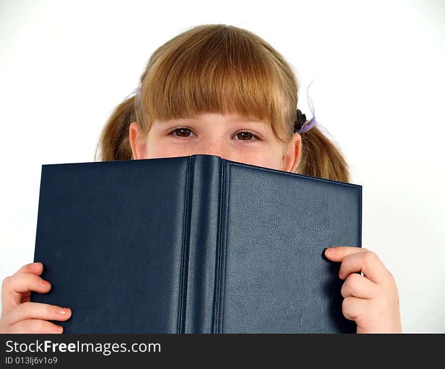 Pretty school girl hiding after notebook. Pretty school girl hiding after notebook