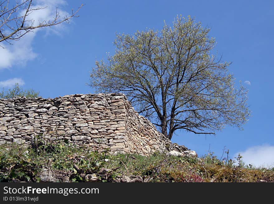 Part of the Saint-Hippolyte medieval ruins, in the town of Cremieu, France. Wall of the old fortifications. Part of the Saint-Hippolyte medieval ruins, in the town of Cremieu, France. Wall of the old fortifications.