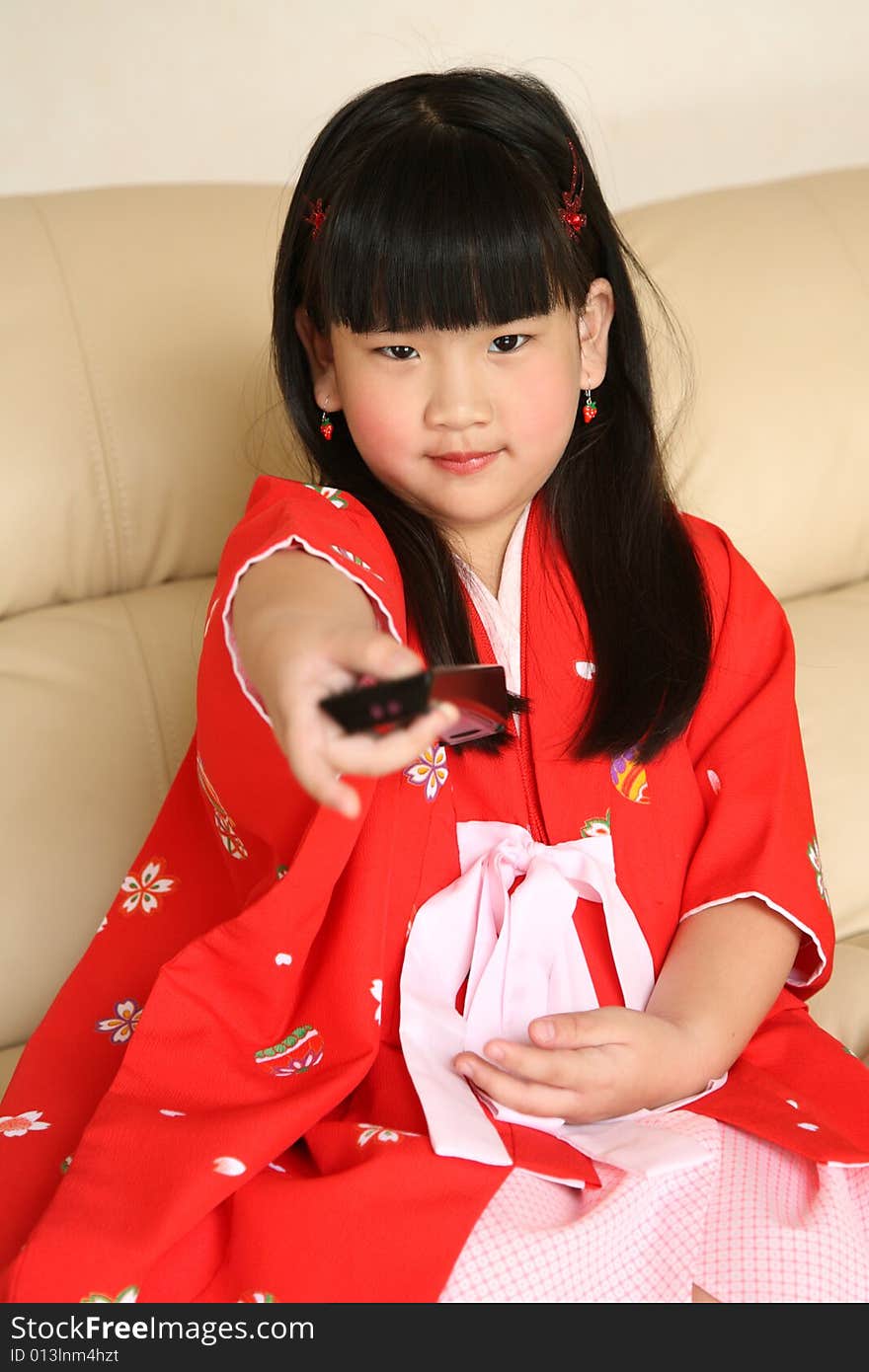 cute little Chinese girl watching TV. cute little Chinese girl watching TV