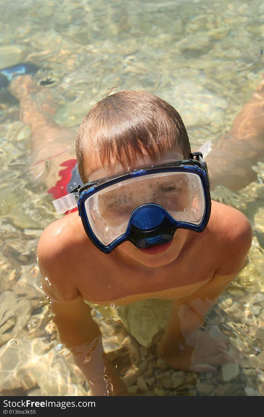 Boy on a beach ready to swim. Boy on a beach ready to swim