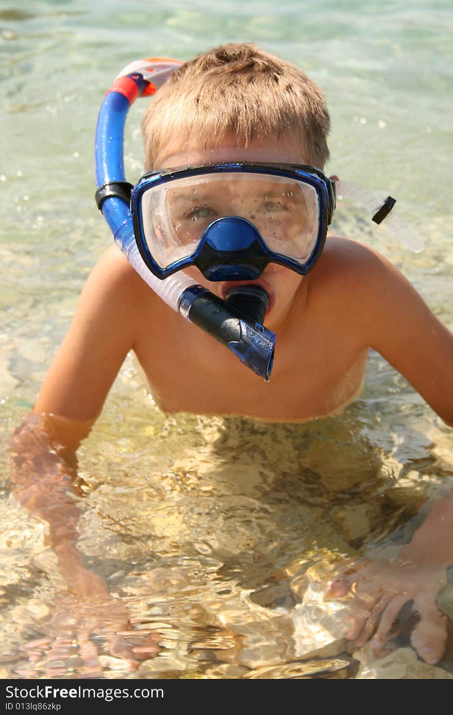 Boy on a beach ready to swim. Boy on a beach ready to swim