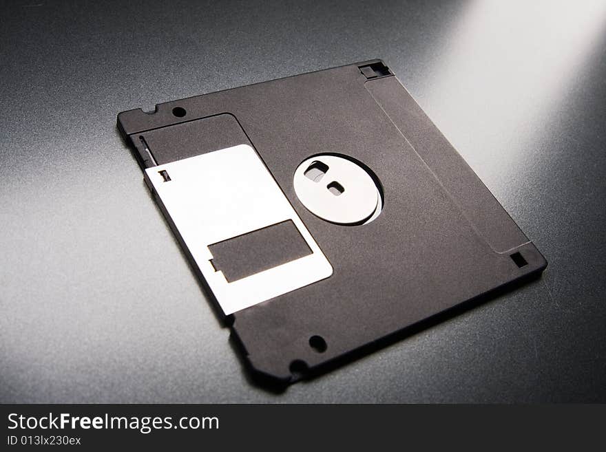 Floppy disk lays on a gray background. Floppy disk lays on a gray background