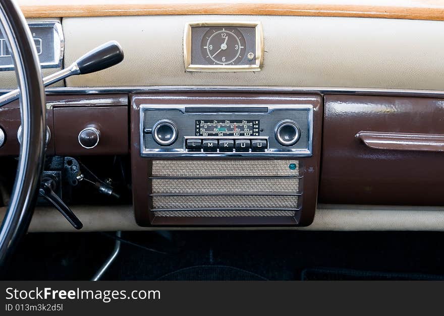 Old style steering wheel and dashboard. It can also be seen the gear lever on th esteering column, the old stereo, speaker and clock. Old style steering wheel and dashboard. It can also be seen the gear lever on th esteering column, the old stereo, speaker and clock.