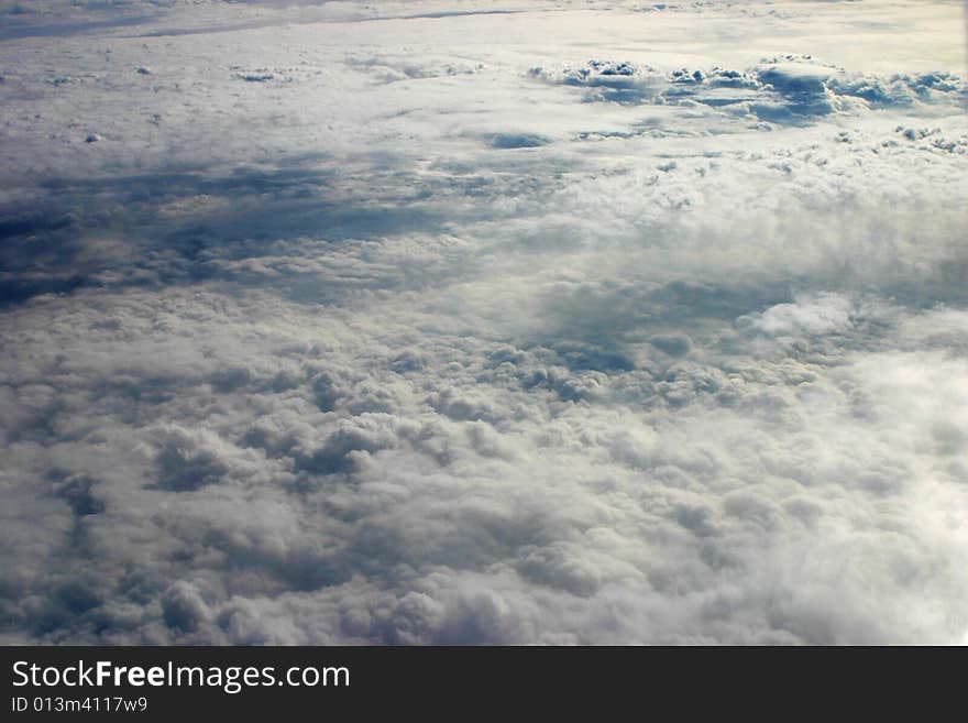 Photograph of clouds taken out of the window of an airplane