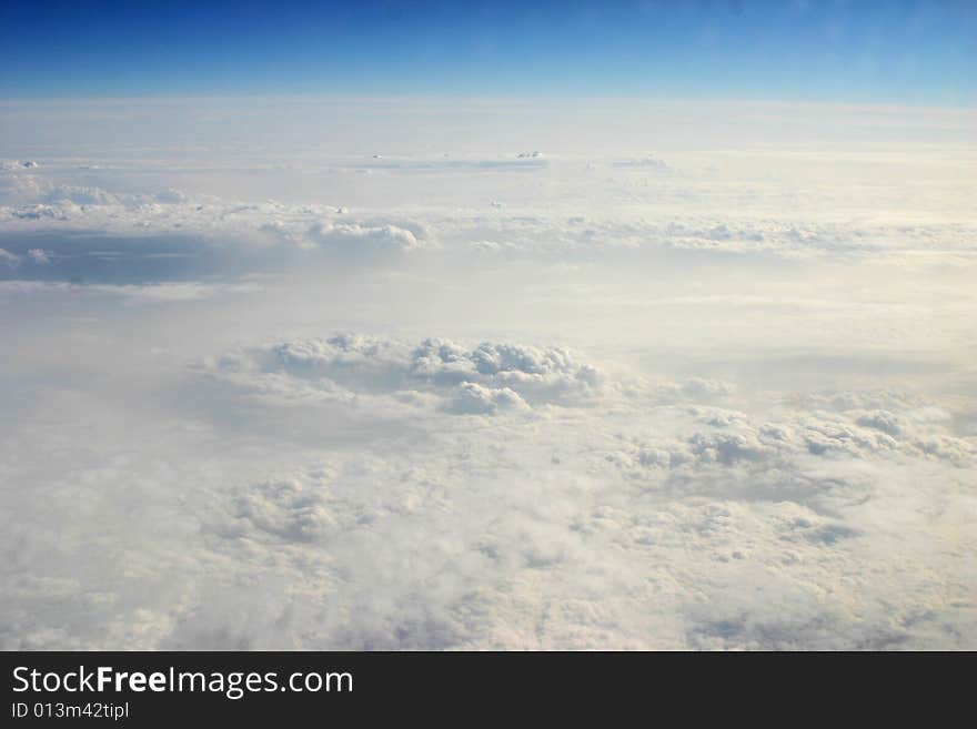 Photograph of clouds taken out of the window of an airplane