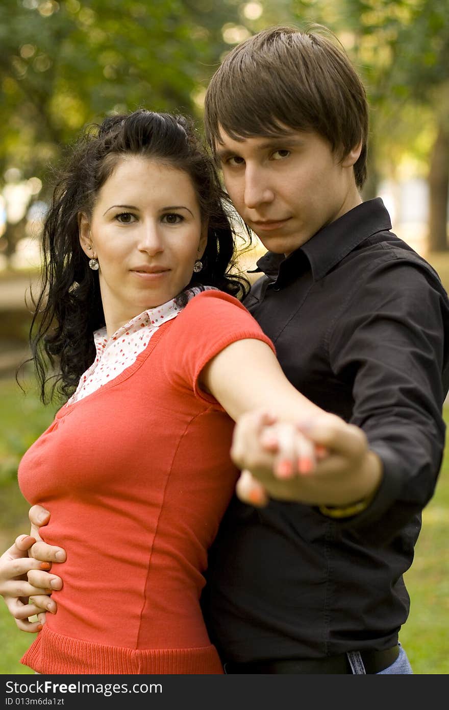 Outdoor portrait of young happy attractive couple together. Outdoor portrait of young happy attractive couple together