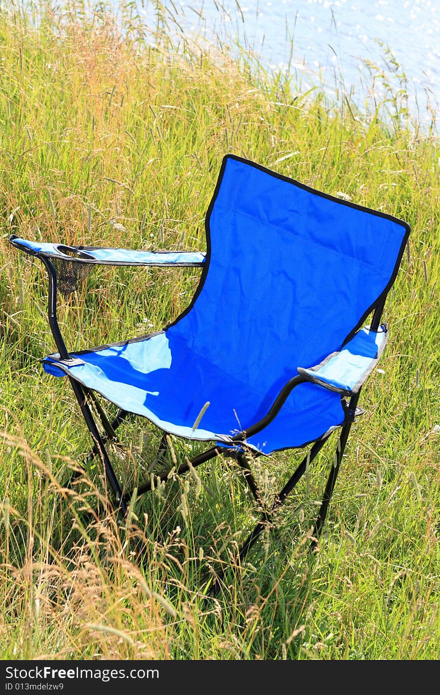 The blue outdoor chaire on river bank