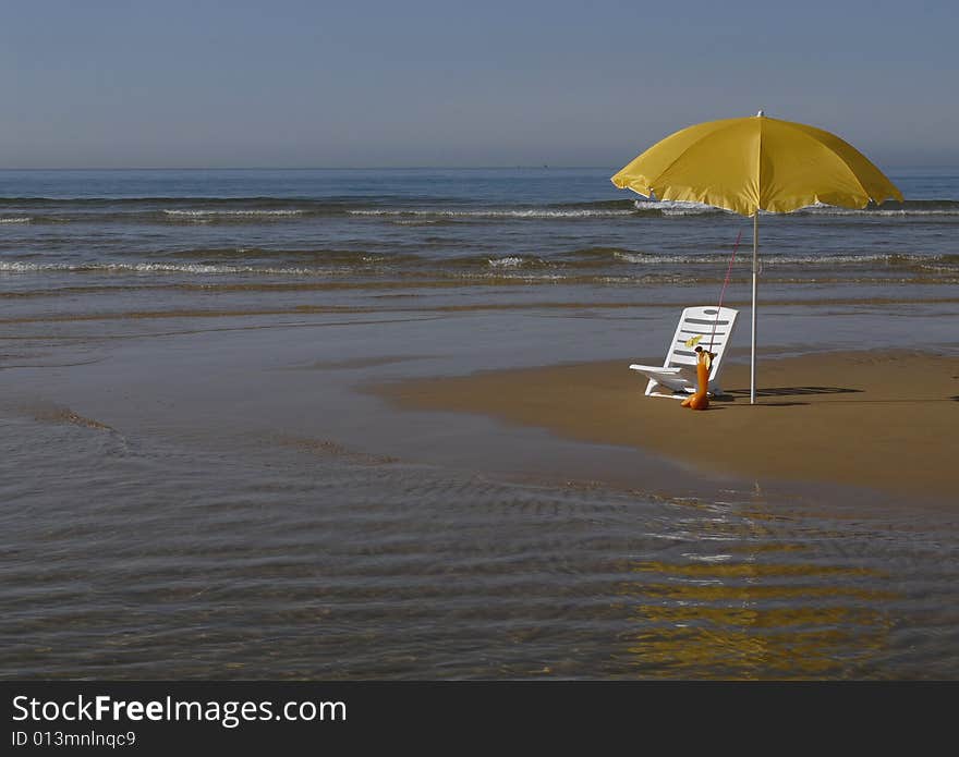 Two beach umbrellas on empty beach and bright blue ocean. Best beach. Two beach umbrellas on empty beach and bright blue ocean. Best beach