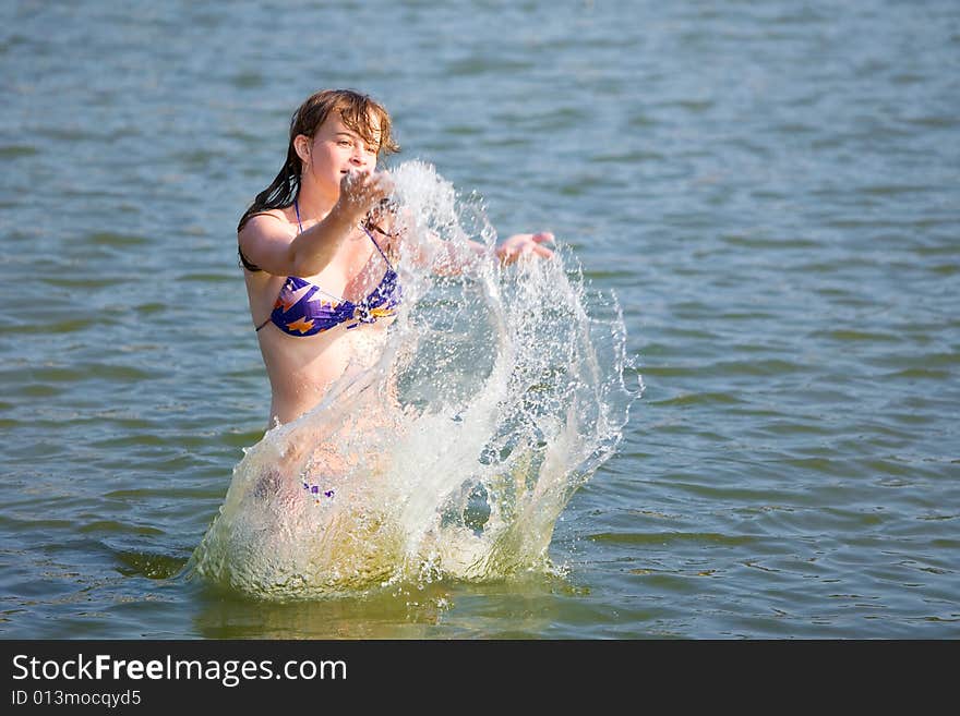 The girl has fun in the summer on water. The girl has fun in the summer on water