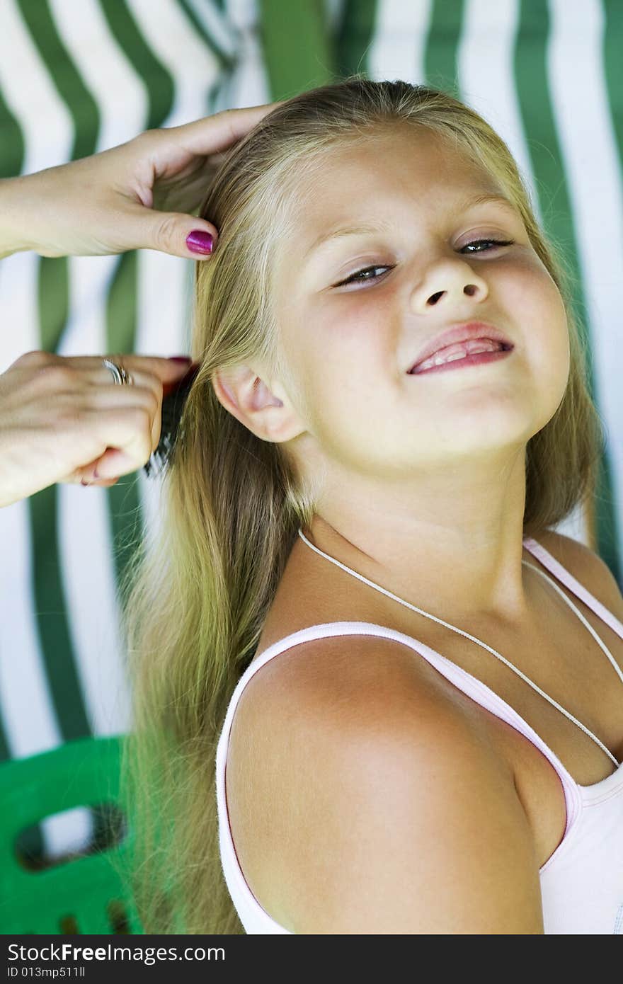 Little blond long hair girl has haircare by stylist. Little blond long hair girl has haircare by stylist.