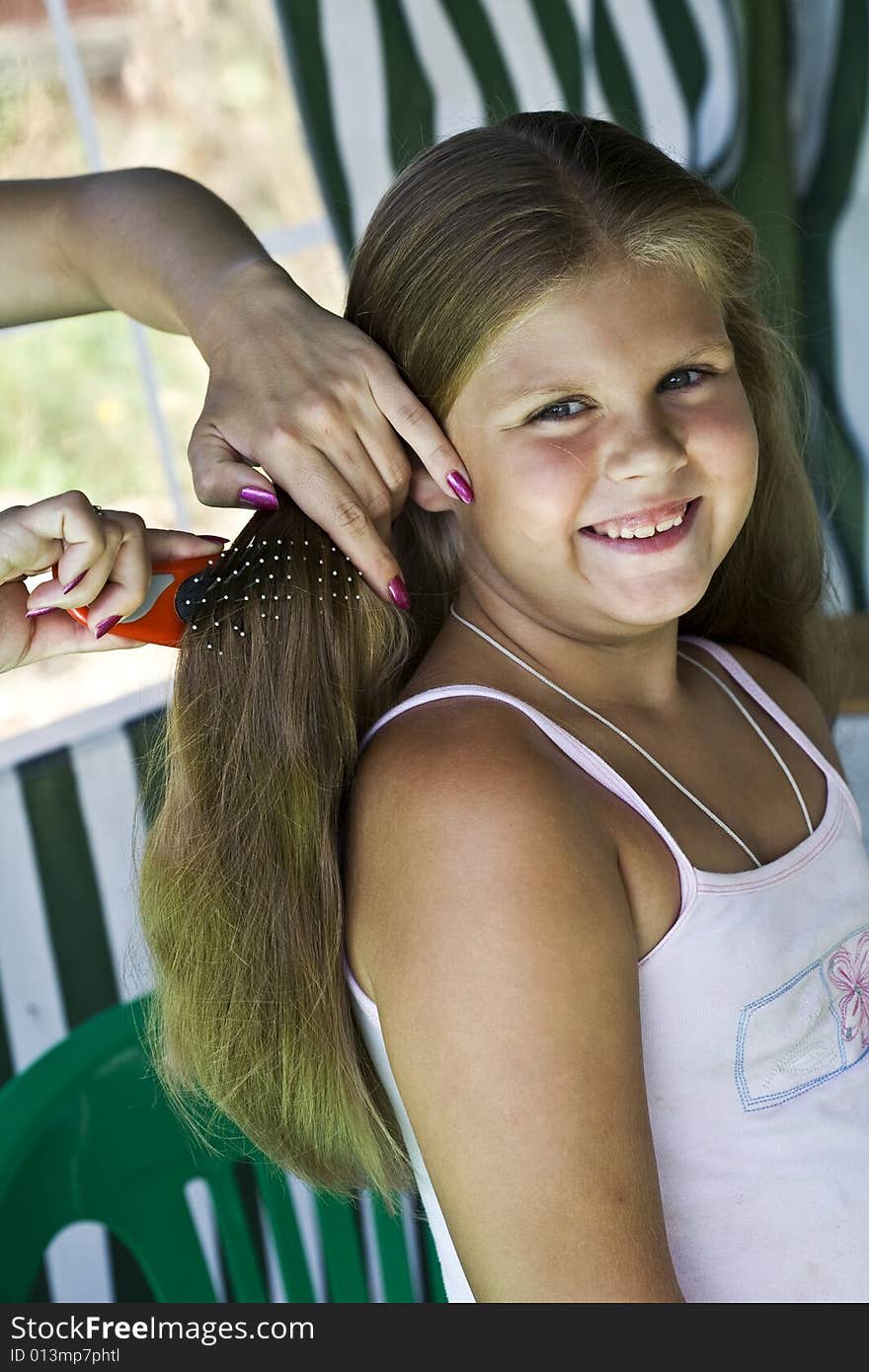 Little blond long hair girl has haircare by stylist. Little blond long hair girl has haircare by stylist.