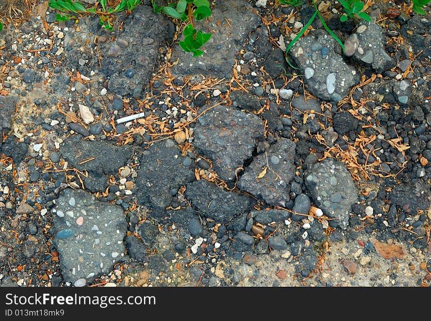 Close-up of destroyed asphalt pavement