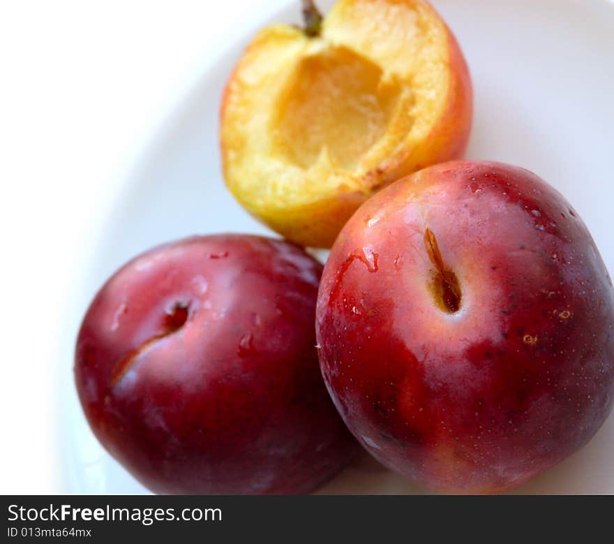 Closeup of three ripe plums