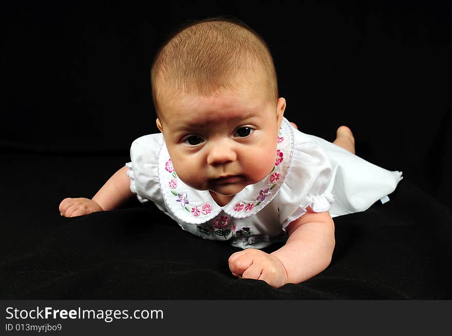 A little cute baby portrait over black. A little cute baby portrait over black